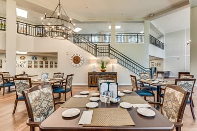 Cozy dining room setup with tables and a large staircase