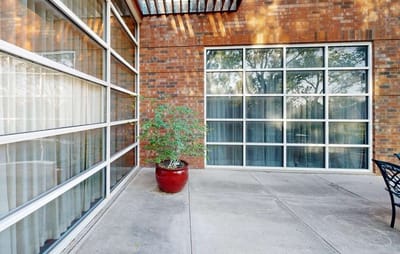 Patio area with large windows and a potted plant