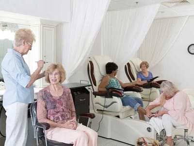 Residents enjoying a group spa day with pedicures and hair styling