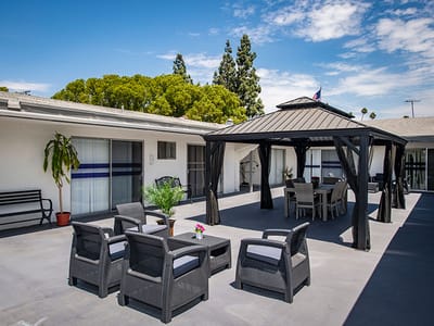 Outdoor seating area with a gazebo and plants