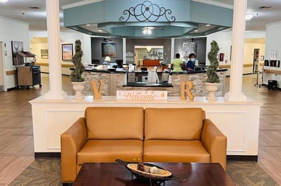 Common area with staff attending to residents