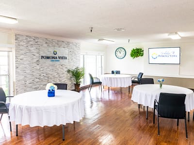 Common area with tables and chairs in Pomona Vista