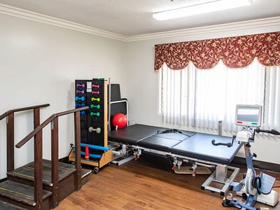 Rehabilitation room with exercise equipment and weights