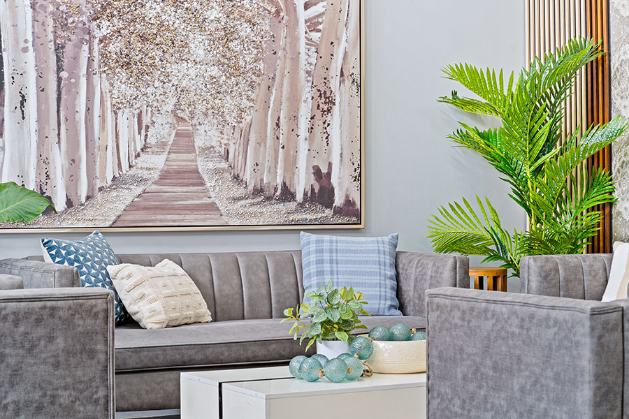Comfortable seating area with artwork and greenery