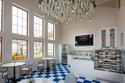 Bright and inviting café area with desserts and seating