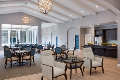 Bright dining area with chairs and tables set up for residents