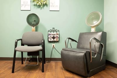 Hair salon chairs in a well-lit interior space