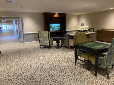 Interior common area with seating and a TV