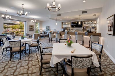 Bright dining area with tables set for a meal