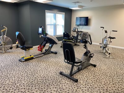 Fitness equipment in a well-lit exercise room