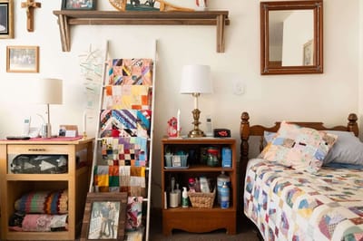 Cozy resident room with quilts and personal items