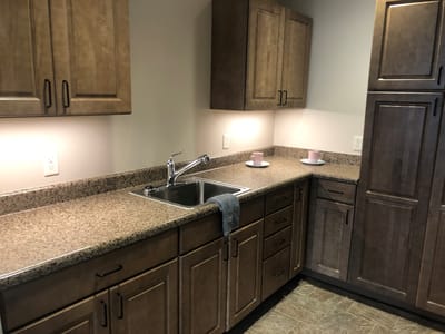 A clean kitchen space with cabinets and sink