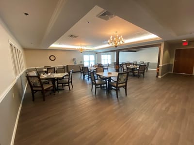 Dining room with tables and chairs, well-lit space