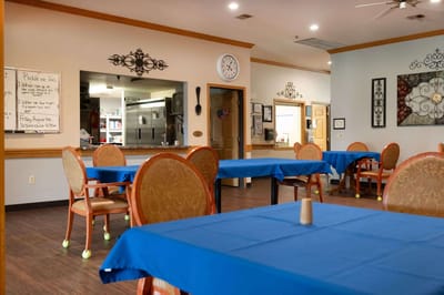 Dining area with blue tables and empty chairs