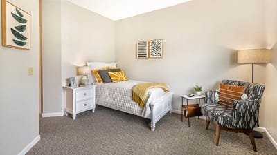 Cozy resident room with bed and chair
