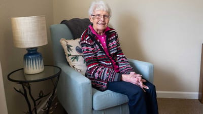 Senior resident sitting in a cozy chair