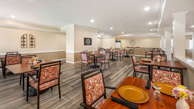 Dining room with tables and chairs set for residents