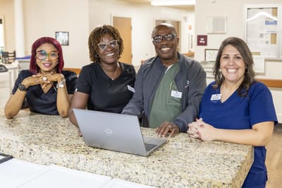 Staff members smiling at reception