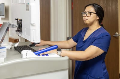 Staff member at a computer station in a healthcare setting