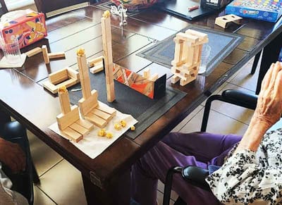 Residents engaging in an activity with building blocks