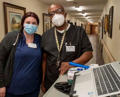 Staff interacting in a facility corridor