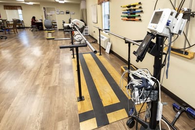 Rehabilitation area with exercise equipment and staff