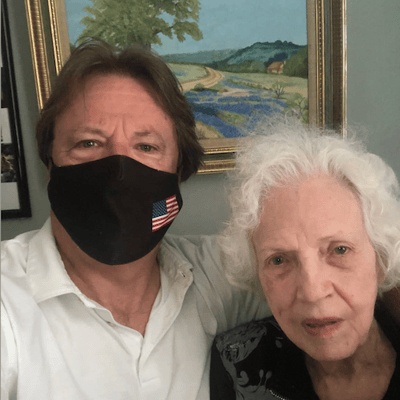 A staff member and a resident posing for a photo indoors