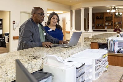 Staff members collaborating at a reception desk in the facility