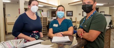 Staff members at the front desk in a welcoming lobby