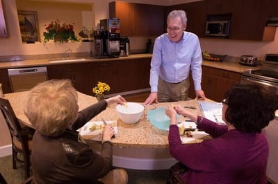 Residents participating in a cooking activity in the kitchen