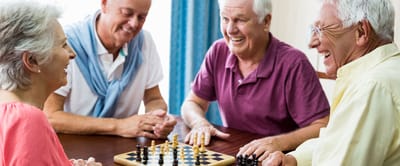 Parkwood Independent Living, independent living in Bedford, TX — Seniors enjoying a lively game of chess together