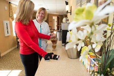 Staff assisting a resident in a common area