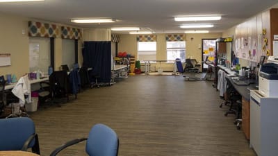 A spacious activity room with equipment and furniture