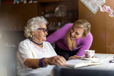 Accent Care – Portland, hospice care in Portland, OR — Elderly woman conversing with a caregiver over tea