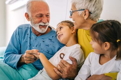 Accent Care – Portland, hospice care in Portland, OR — Grandparents enjoying time with young grandchildren indoors