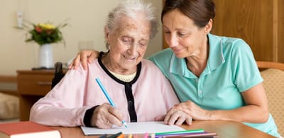 Resident and staff member enjoying art activity