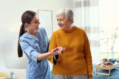 Accent Care – Portland, hospice care in Portland, OR — Caregiver assisting an elderly woman in a cozy setting