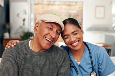 Accent Care – Portland, hospice care in Portland, OR — Smiling senior and caregiver in a cozy setting
