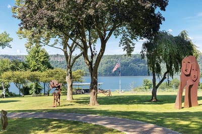Outdoor space with sculptures and river view.