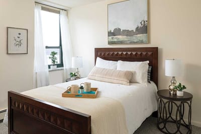 Cozy bedroom setup with bedside lamps and artwork