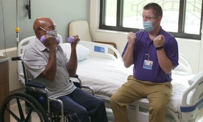 Resident and staff engaging in physical activity