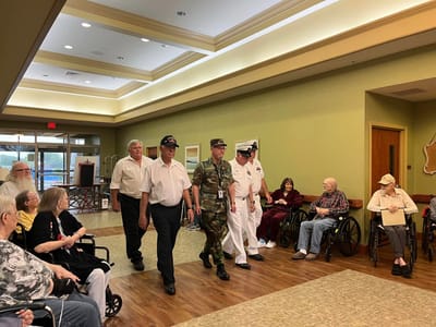 Residents engaging with military personnel during an event.