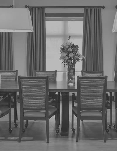 Clean dining area with a floral centerpiece.