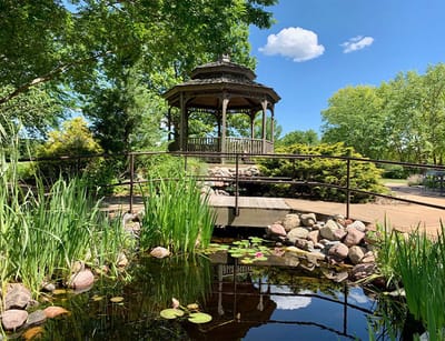 Scenic gazebo surrounded by greenery and water
