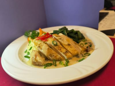 Plated meal of grilled chicken and vegetables