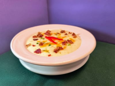 Creamy soup garnished with colorful toppings