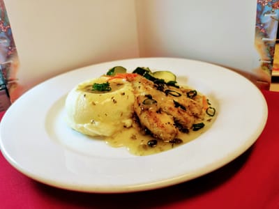 Plate of food with mashed potatoes and fish