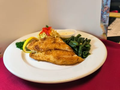 Plate of fried fish with sides and garnish