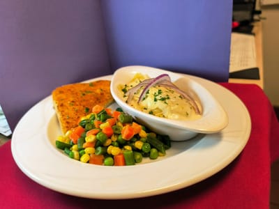 Plated meal featuring vegetables and fish
