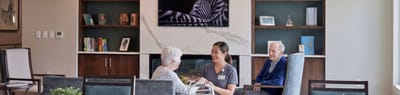 Residents and staff chatting in a common area.